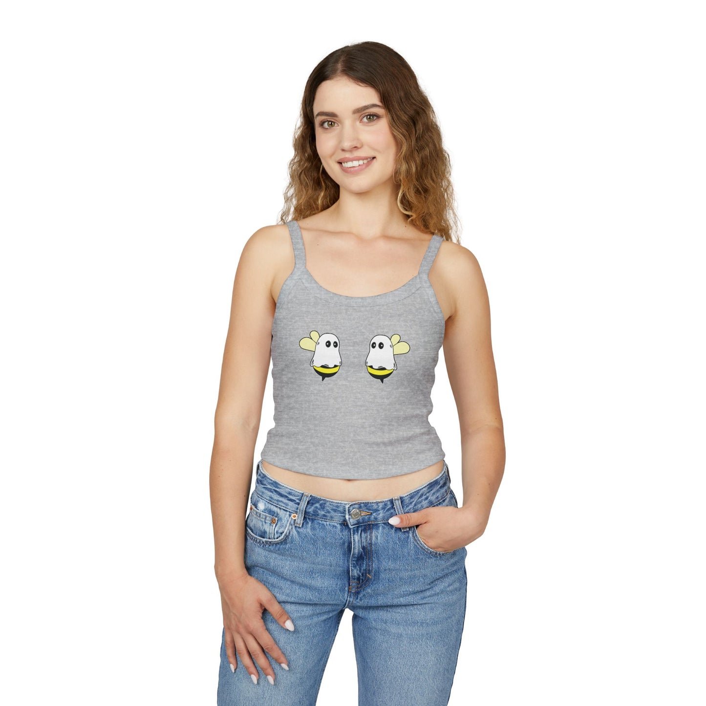 Woman wearing a gray tank top with cartoon bee designs and blue jeans on a white background