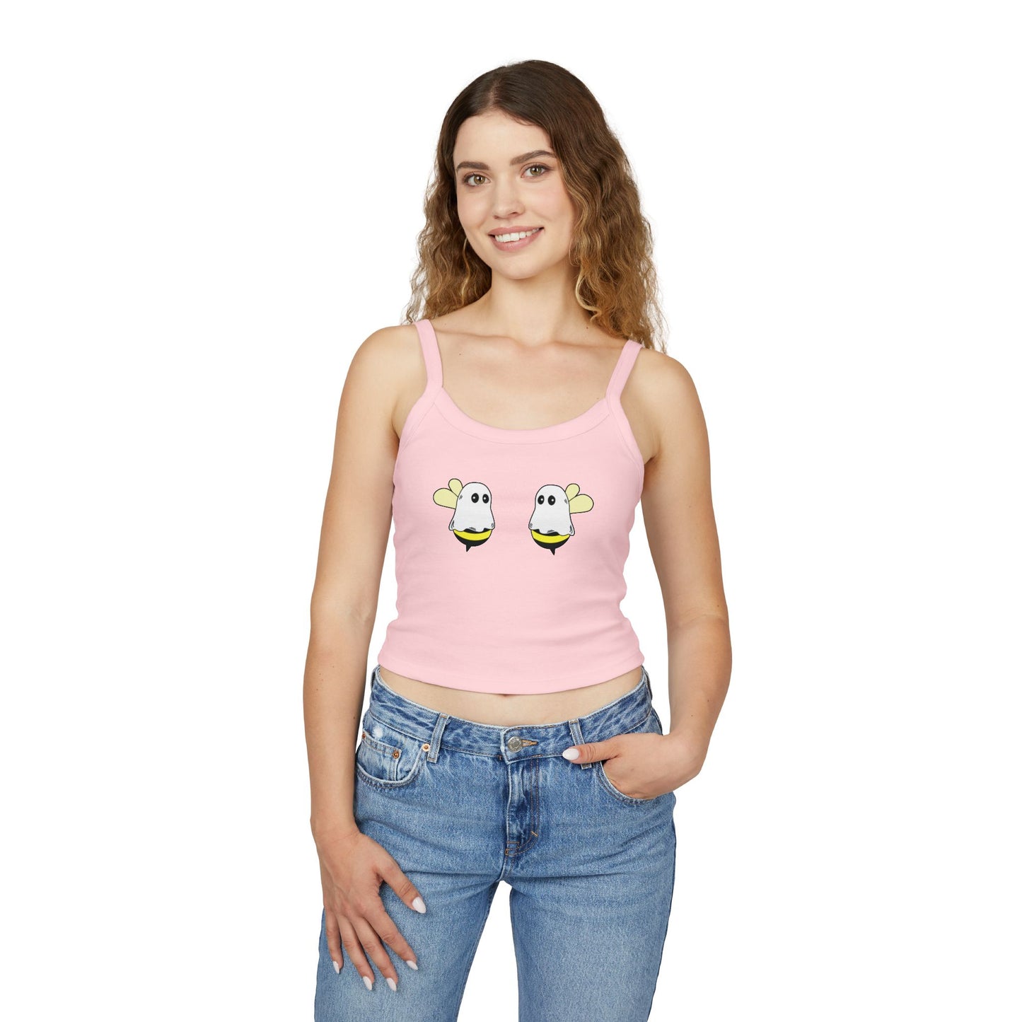 Woman wearing a pink tank top with cartoon designs and blue jeans on a white background