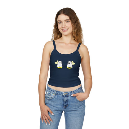 Woman wearing a navy tank top with ghost designs on a white background