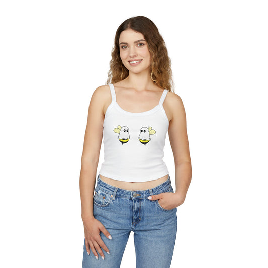 Woman wearing a white tank top with cartoon bee designs on a white background