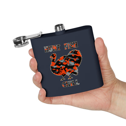Black flask with hunting-themed design held in a hand against a white background