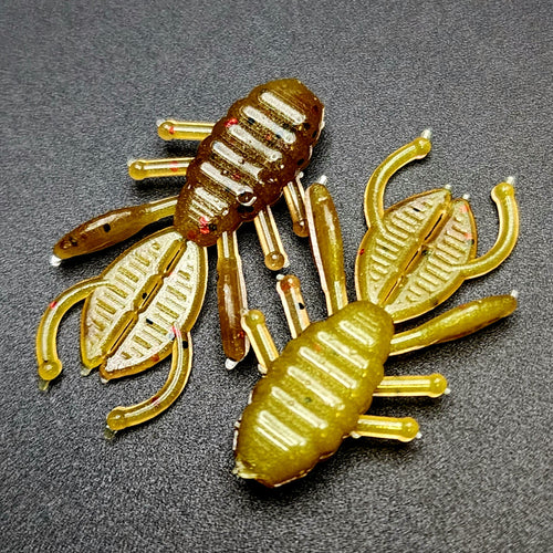 Two yellow and brown scorpion-shaped objects on a gray background