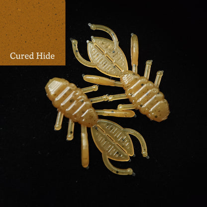 Two crawfish-shaped fishing lures on a black background with 'Cured Hide' label.