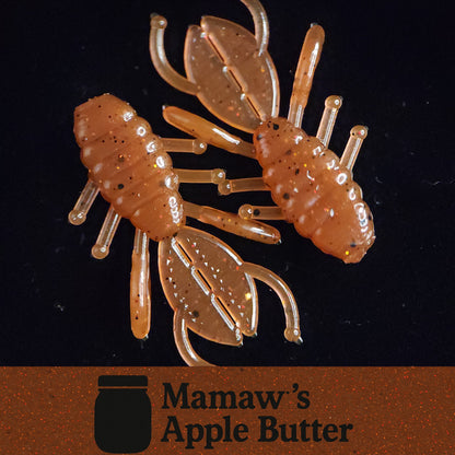 Transparent crawfish-shaped fishing lure with 'Mamaw's Apple Butter' branding on a dark background.