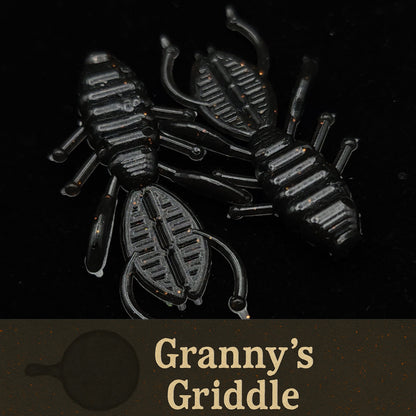 Black plastic scorpion-shaped object with 'Granny's Griddle' branding on a black background