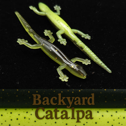 Two green lizard-shaped fishing lures on a black background with 'Backyard Catalpa' branding.