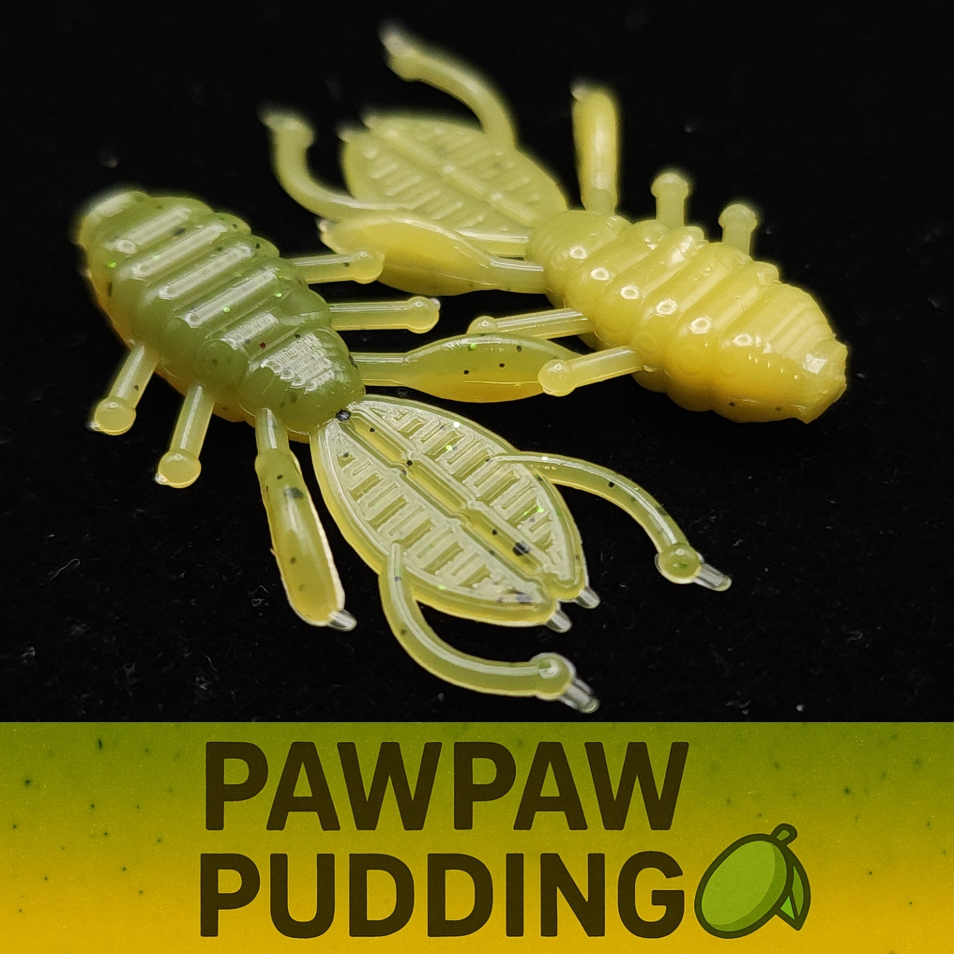 Two green and yellow plastic insects with 'Pawpaw Pudding' text and logo on a black background.