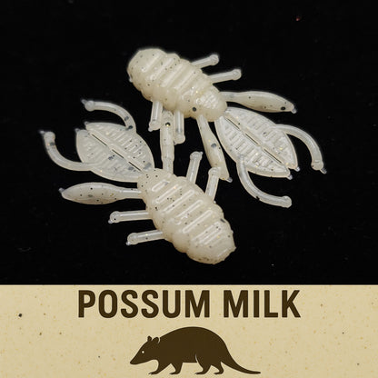 Two white crawfish-shaped fishing lures on a black background with 'Possum Milk' text and possum illustration.