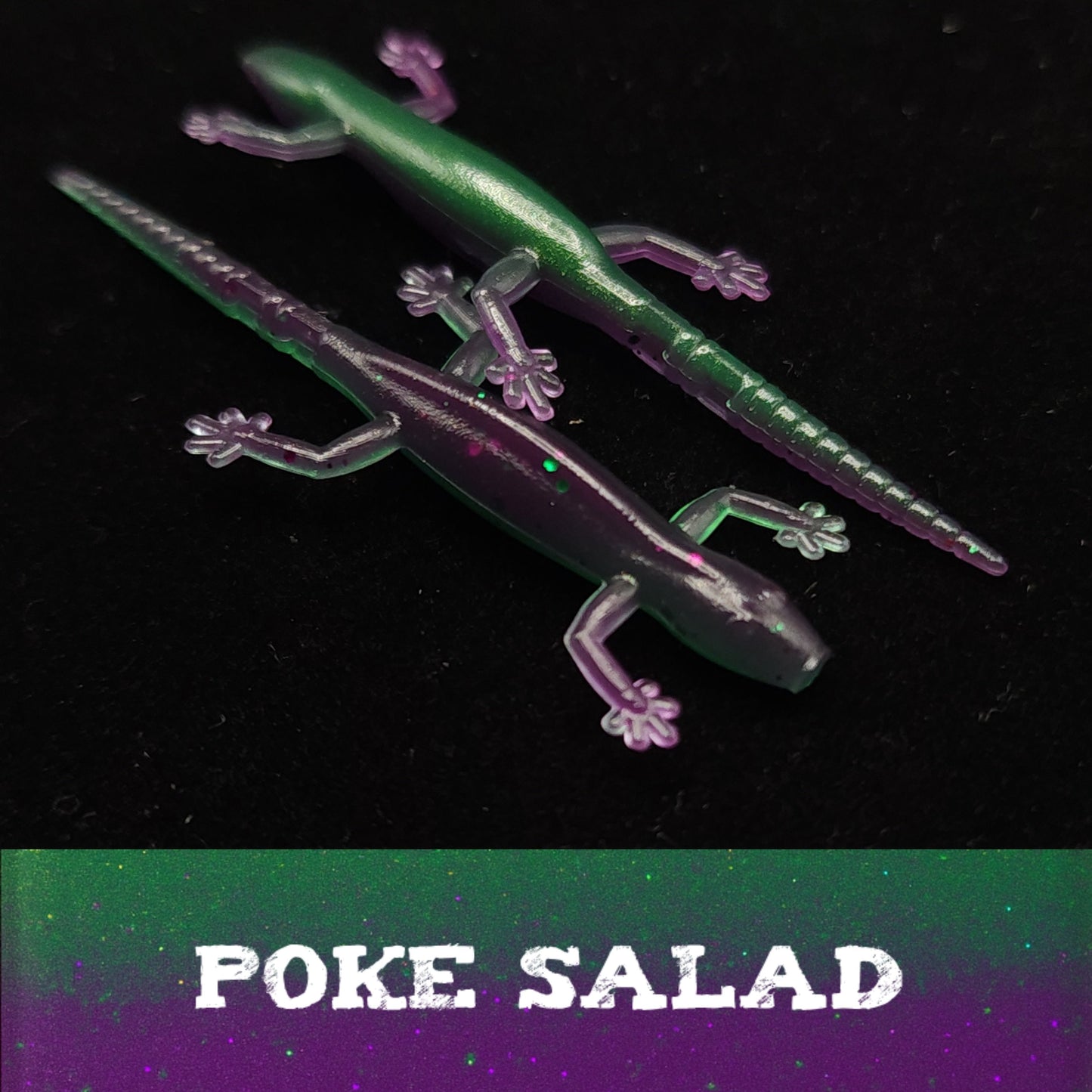 Glowing green and purple lizard-shaped objects on a black background with 'POKE SALAD' text.