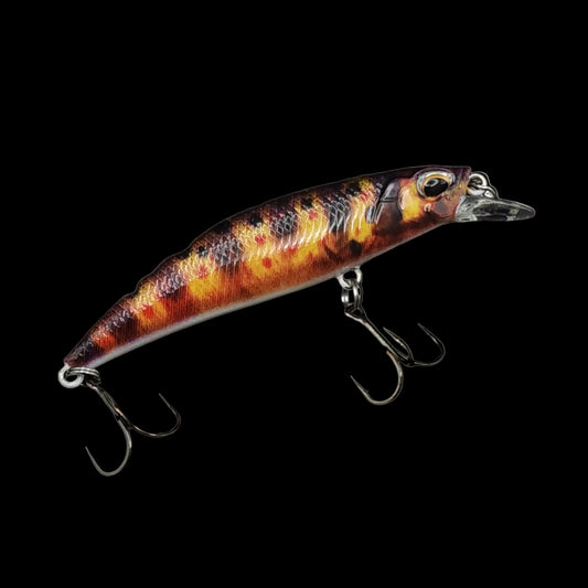 Fishing lure with a metallic finish on a black background