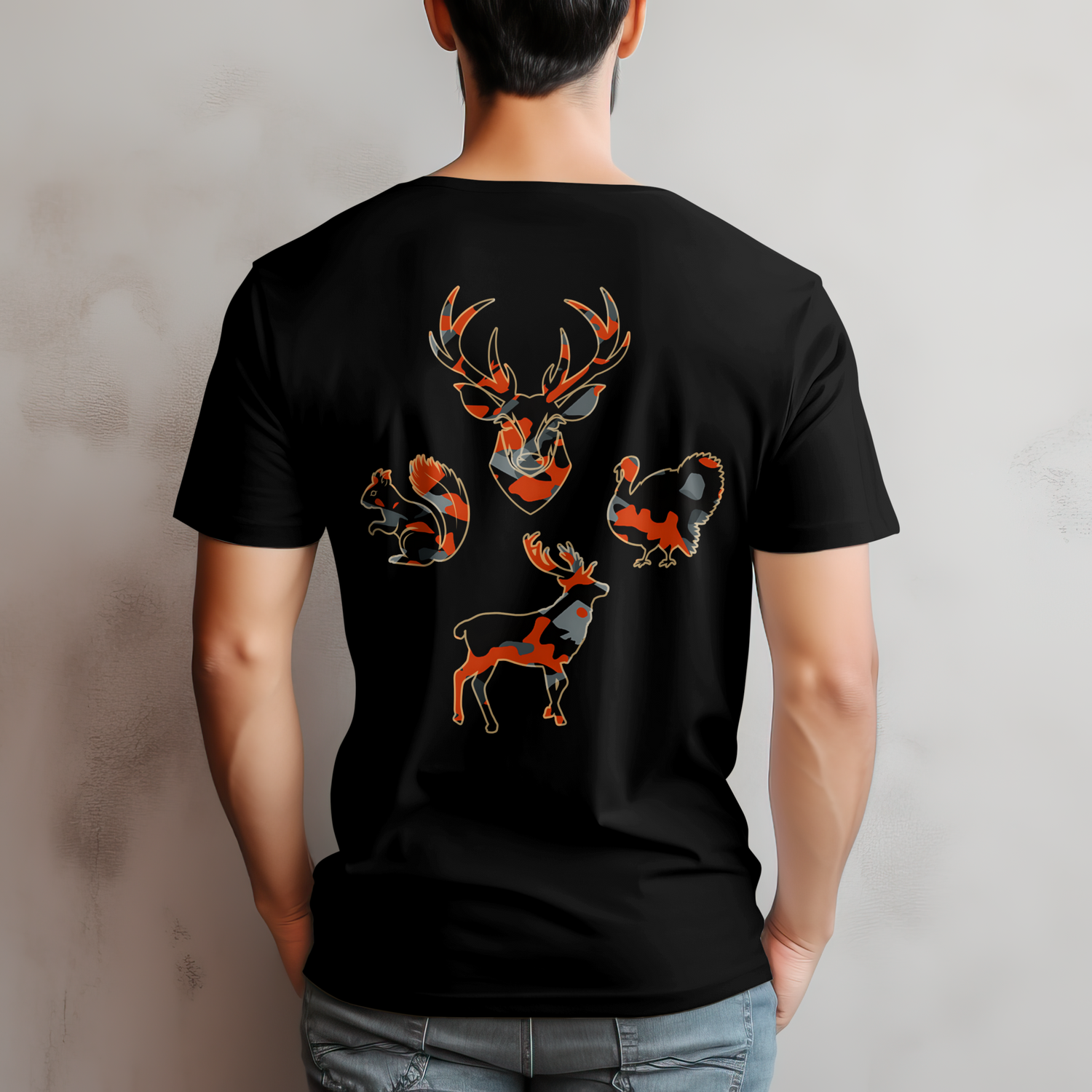 Person wearing a black t-shirt with deer and squirrel designs on the back against a gray background